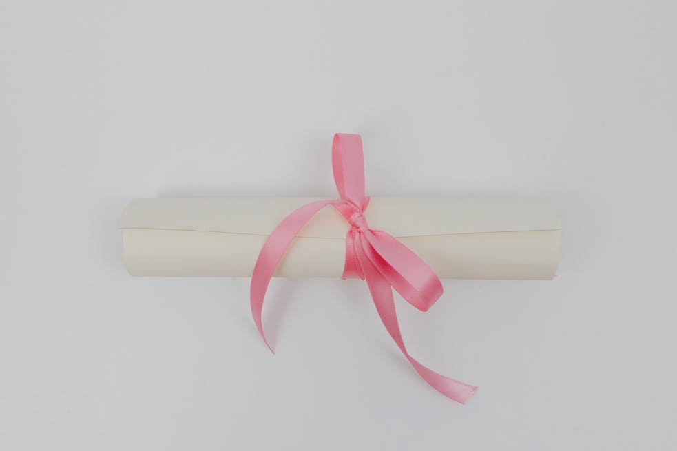 White Rolled Paper with Pink Ribbon